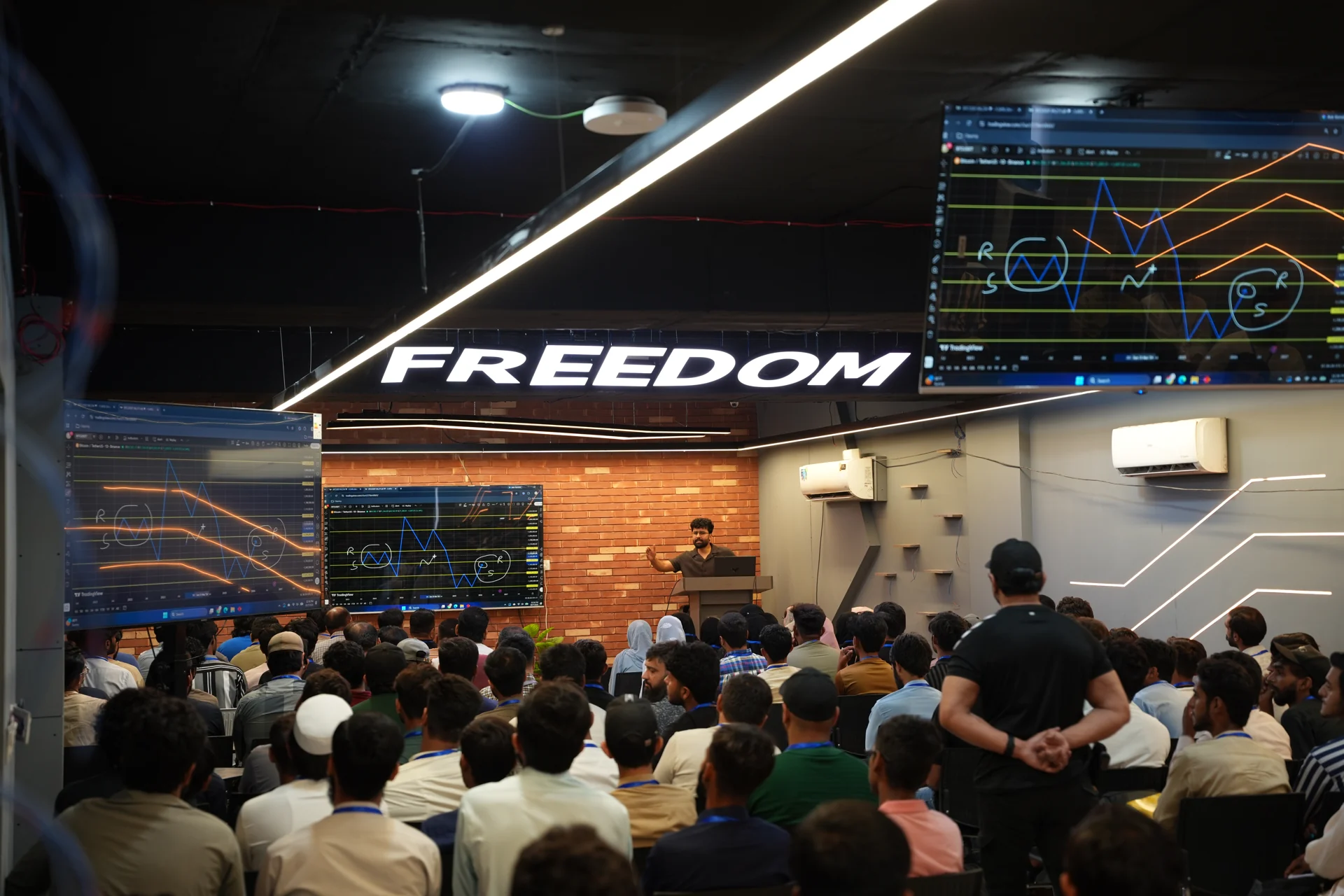 SIR NOMAN explaining charts during a Freedom Institute class